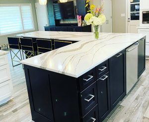 An L-shapped kitchen island helps illustrate the choices there are when choosing a kitchen island vs. peninsula for your needs.