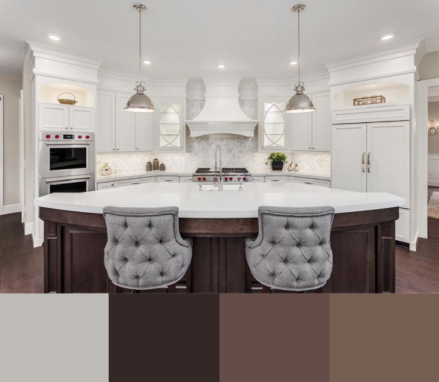 A luxurious kitchen with white cabinetry, a curved center island featuring a dark wood base and a white countertop, and upholstered counter stools. The backsplash is white marble, and the pendant lights are a classic design.