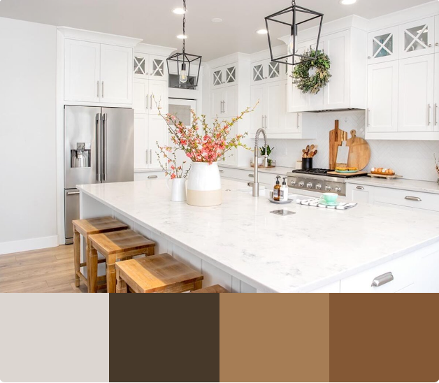 A bright and airy kitchen with white cabinets, a large white quartz countertop island, and a farmhouse sink. The backsplash is a white subway tile, and the range hood is a copper-colored metal. 