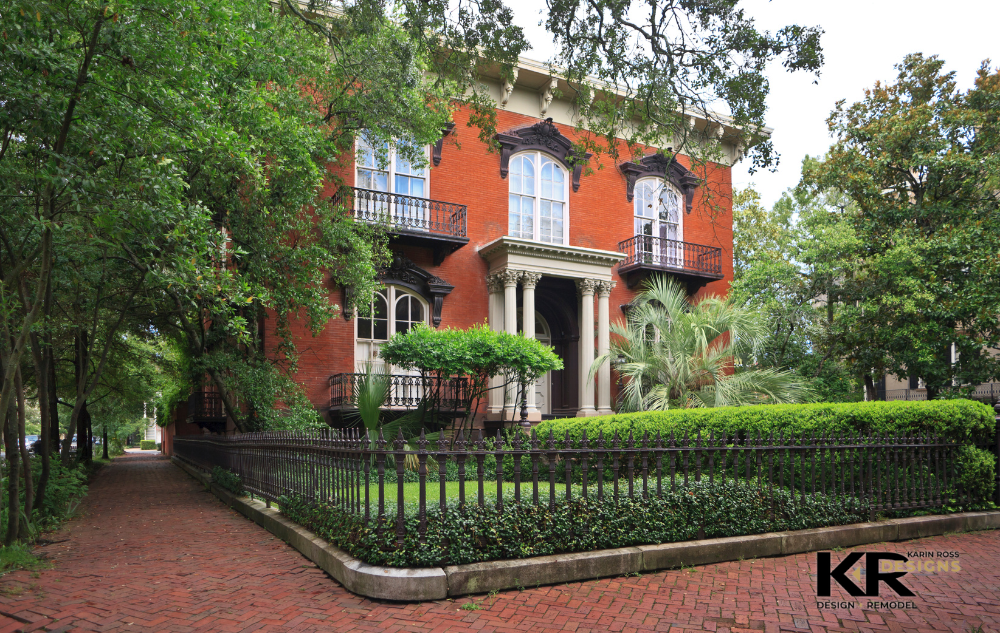 A beautiful historic home in Kansas City made of orange-red bricks and surrounding be greenery and foliage exemplifies a historic home that can be renovated by Karin Ross Designs.